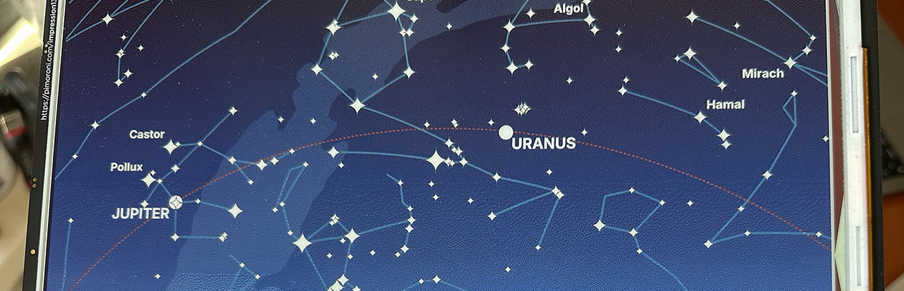 Detail of the Inky Impression e-ink display with a star map depicting on it.